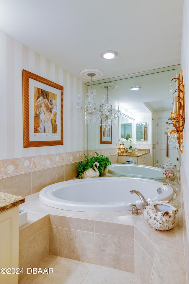 bathroom with vanity, tile patterned floors, and tiled tub