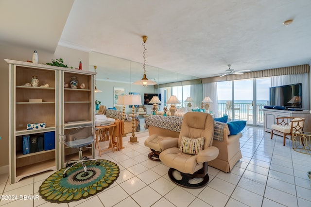 living room with a wall of windows, light tile patterned floors, ceiling fan, and crown molding