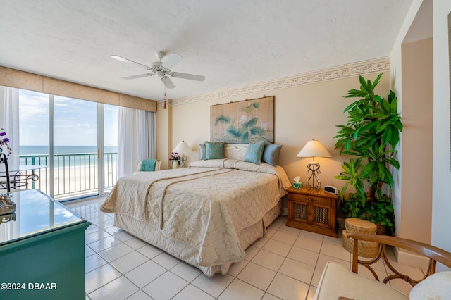 bedroom featuring ceiling fan, light tile patterned floors, a water view, and access to outside