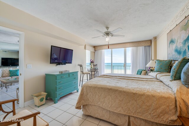 bedroom featuring a textured ceiling, access to outside, ceiling fan, and light tile patterned flooring