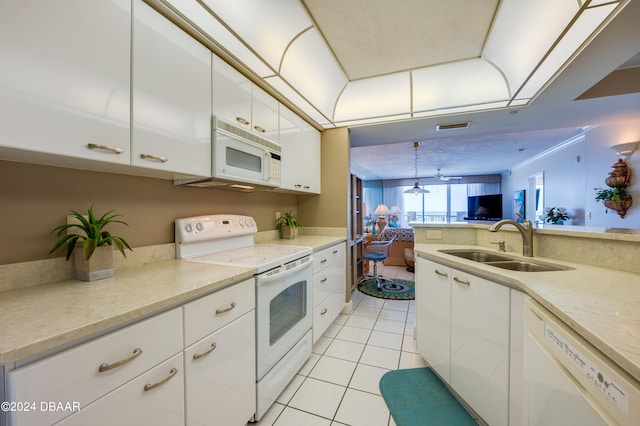 kitchen featuring sink, light tile patterned floors, decorative light fixtures, white appliances, and white cabinets