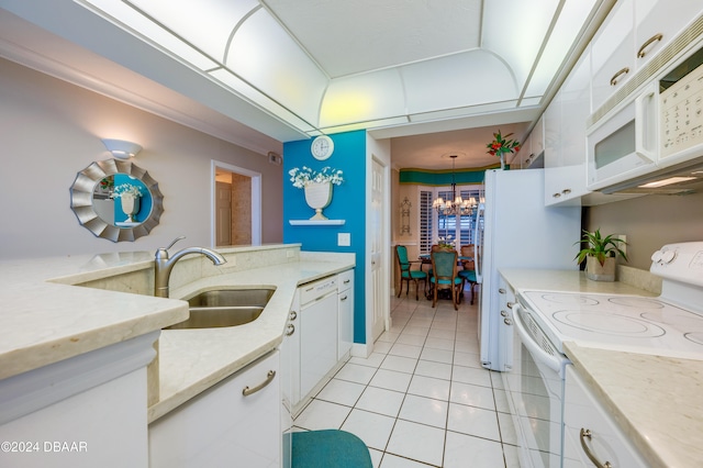 kitchen featuring white appliances, white cabinetry, sink, and a notable chandelier