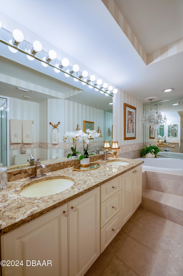 bathroom with tiled bath, tile patterned flooring, and vanity