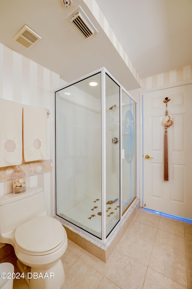 bathroom with walk in shower, tile patterned flooring, and toilet