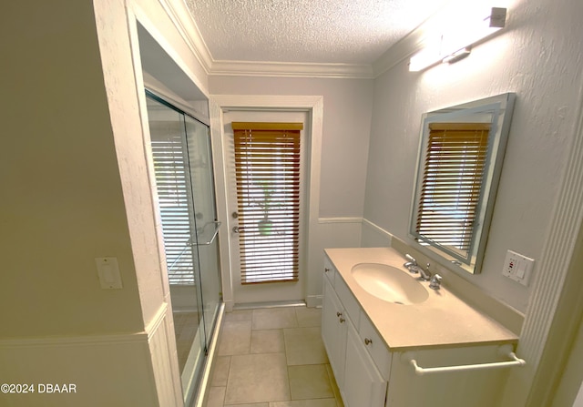 3 Tomoka View Dr, Ormond Beach, FL 32174 - bathroom with a textured ceiling, vanity, a shower stall, tile patterned floors, and crown molding