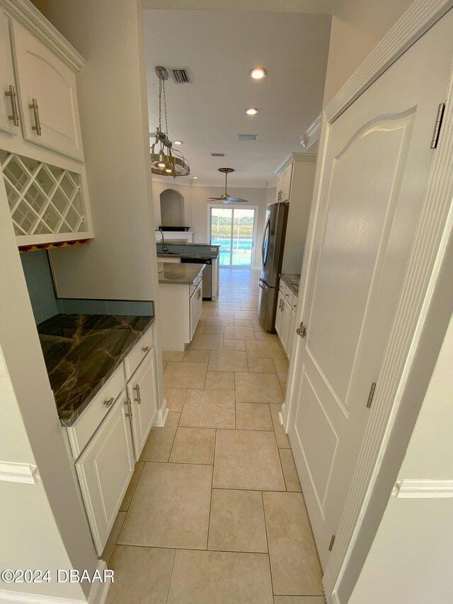 3 Tomoka View Dr, Ormond Beach, FL 32174 - kitchen with appliances with stainless steel finishes, white cabinetry, recessed lighting, pendant lighting, and crown molding