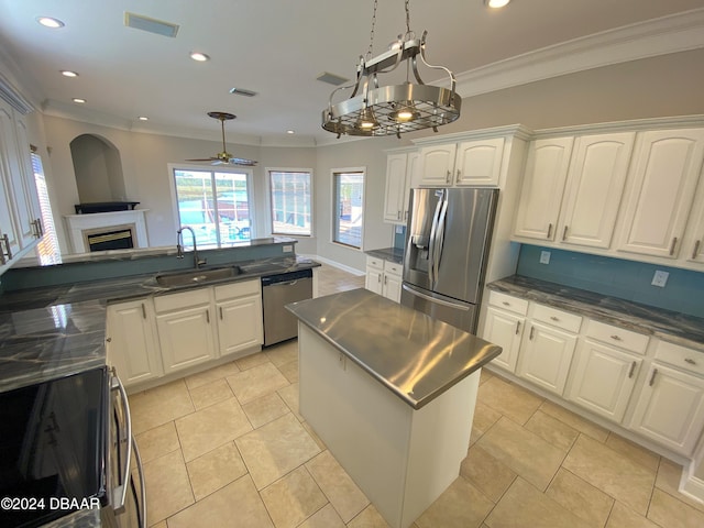 3 Tomoka View Dr, Ormond Beach, FL 32174 - kitchen with a sink, appliances with stainless steel finishes, a fireplace, crown molding, and white cabinets
