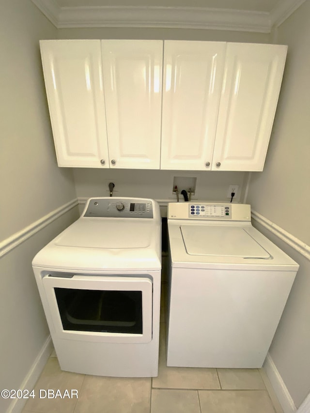 3 Tomoka View Dr, Ormond Beach, FL 32174 - washroom featuring washing machine and clothes dryer, cabinet space, baseboards, crown molding, and light tile patterned floors