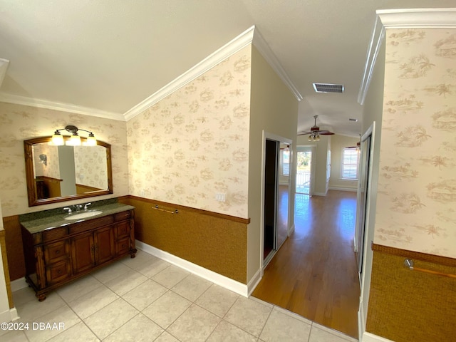 3 Tomoka View Dr, Ormond Beach, FL 32174 - hall featuring crown molding, a sink, wainscoting, vaulted ceiling, and light wood-type flooring