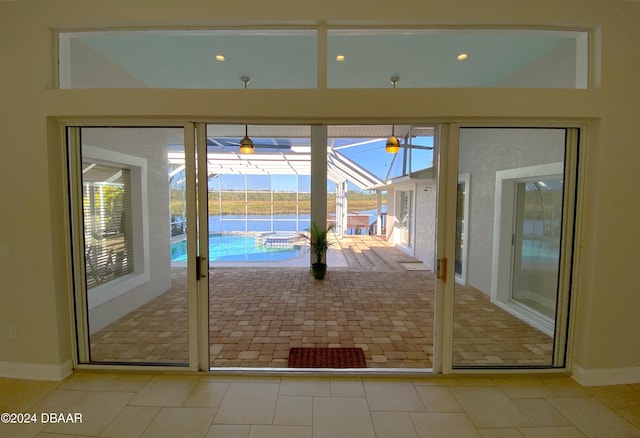 3 Tomoka View Dr, Ormond Beach, FL 32174 - doorway featuring a sunroom, baseboards, and tile patterned flooring
