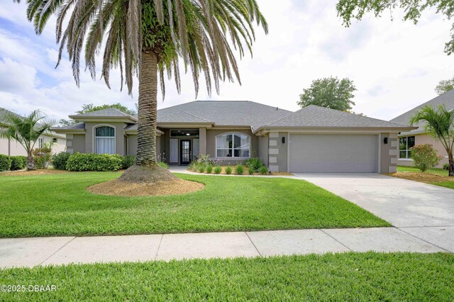 single story home featuring an attached garage, driveway, a front yard, and stucco siding
