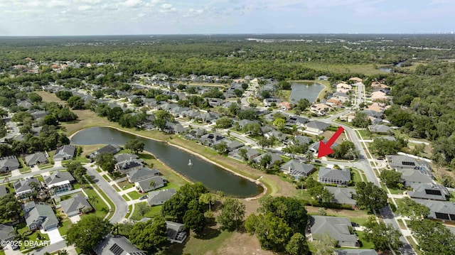 birds eye view of property with a water view, a residential view, and a forest view