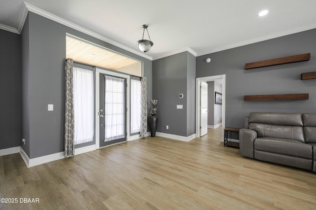 living room featuring baseboards, ornamental molding, and light wood-style flooring