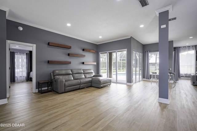 living room with recessed lighting, ornamental molding, light wood-type flooring, and visible vents