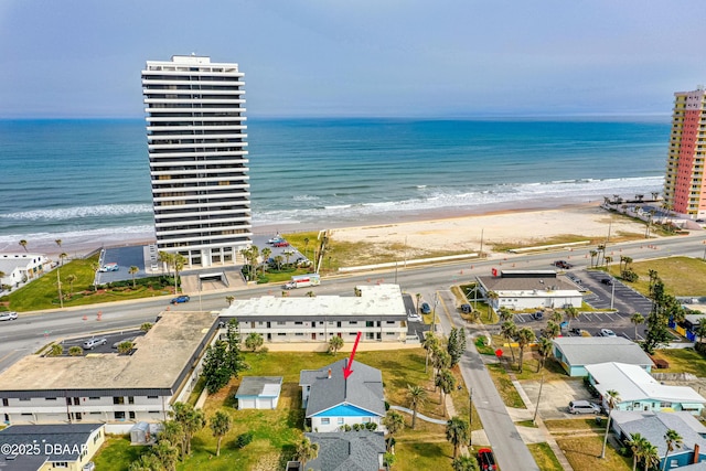 aerial view with a water view and a beach view