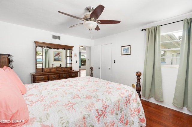 bedroom with ceiling fan and dark hardwood / wood-style floors