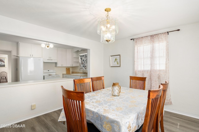 dining area featuring sink and dark hardwood / wood-style flooring