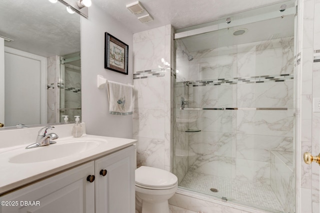 bathroom featuring a marble finish shower, vanity, toilet, and visible vents