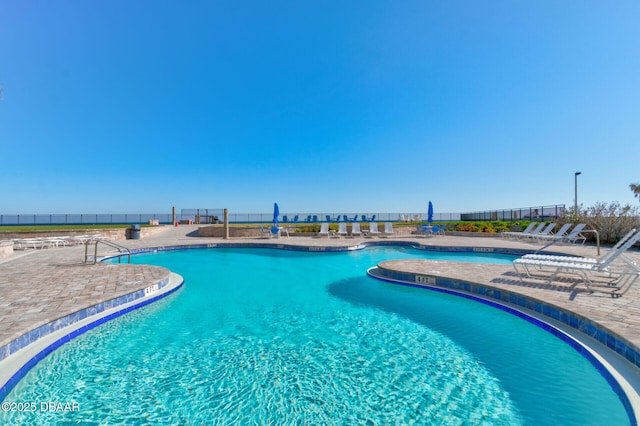 community pool featuring a patio area and fence