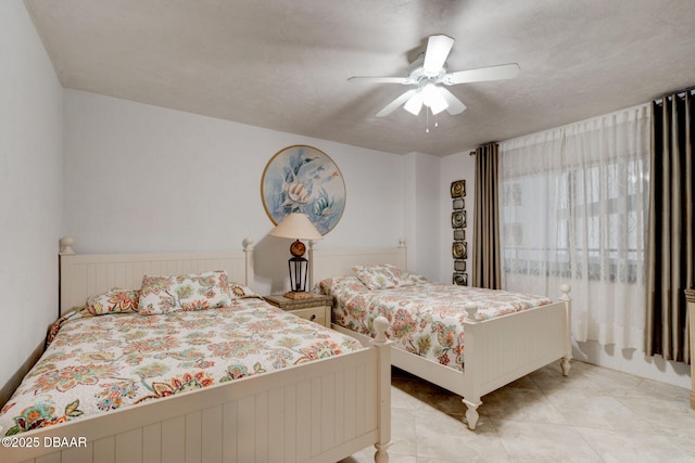 bedroom featuring tile patterned flooring and ceiling fan