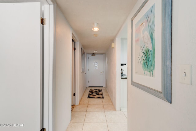 hall with light tile patterned floors