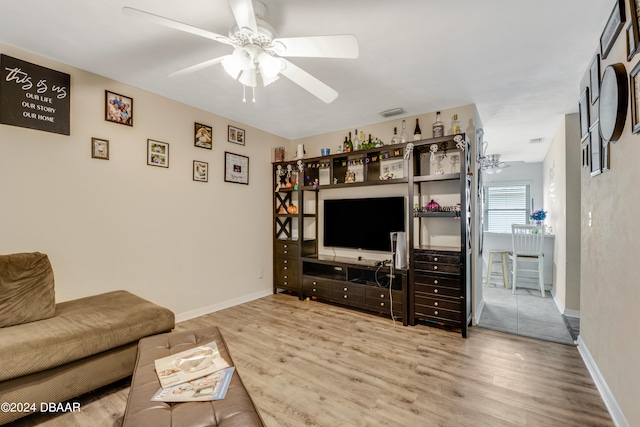 living room with hardwood / wood-style floors and ceiling fan