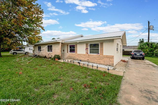 ranch-style house with a front lawn