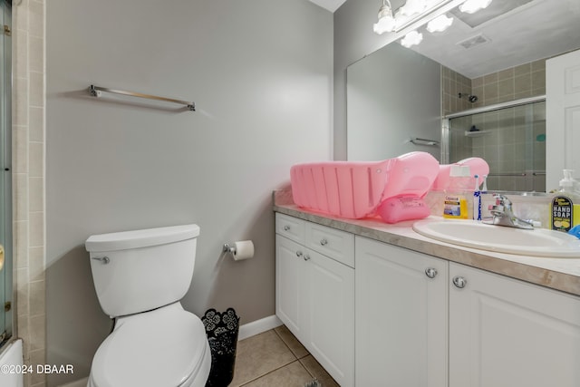 bathroom featuring tile patterned flooring, vanity, and toilet