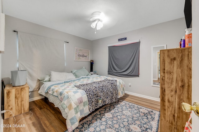 bedroom with hardwood / wood-style flooring and ceiling fan