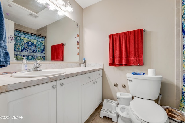 bathroom with vanity, tile patterned floors, and toilet