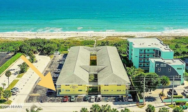birds eye view of property featuring a beach view and a water view
