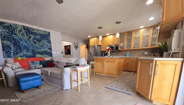 kitchen featuring light countertops, glass insert cabinets, stainless steel appliances, recessed lighting, and light tile patterned flooring