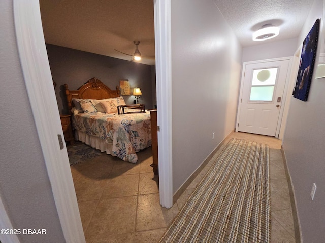 bedroom with a textured ceiling and baseboards