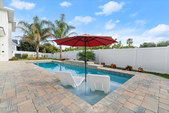 view of swimming pool with central AC and a patio