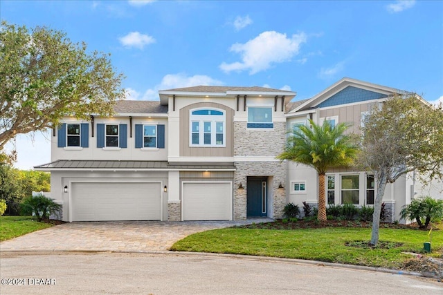 view of front of home featuring a garage and a front yard