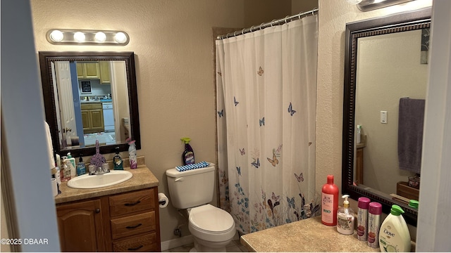 full bath with toilet, curtained shower, a textured wall, and vanity