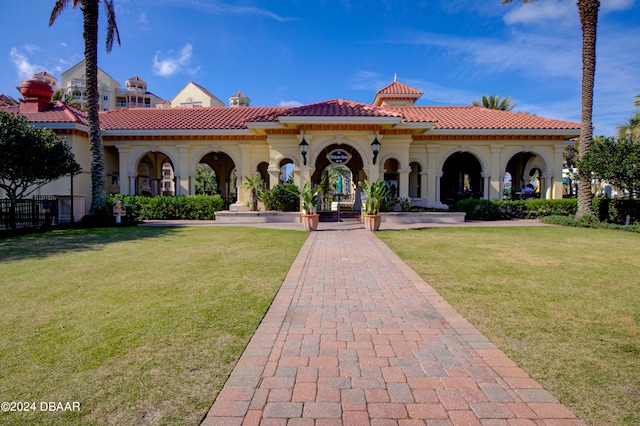 mediterranean / spanish house with a front yard