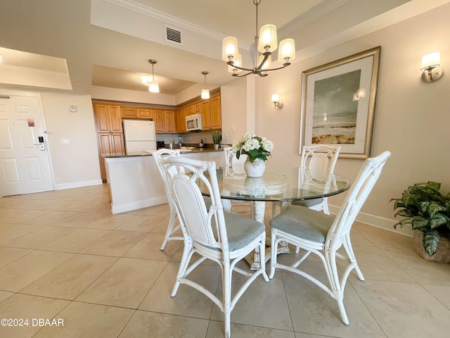 tiled dining area with crown molding and a notable chandelier