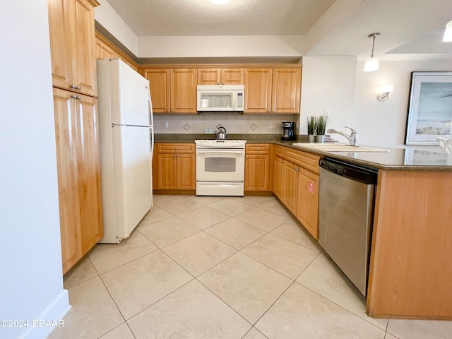 kitchen featuring sink, light tile patterned floors, white appliances, pendant lighting, and decorative backsplash