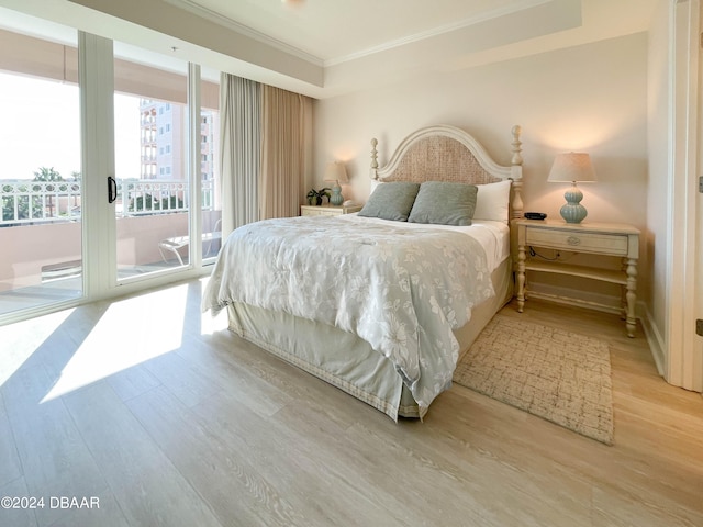 bedroom with access to exterior, light wood-type flooring, and crown molding