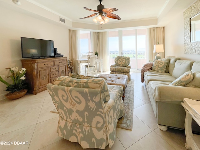 living room with ceiling fan, light tile patterned floors, and crown molding