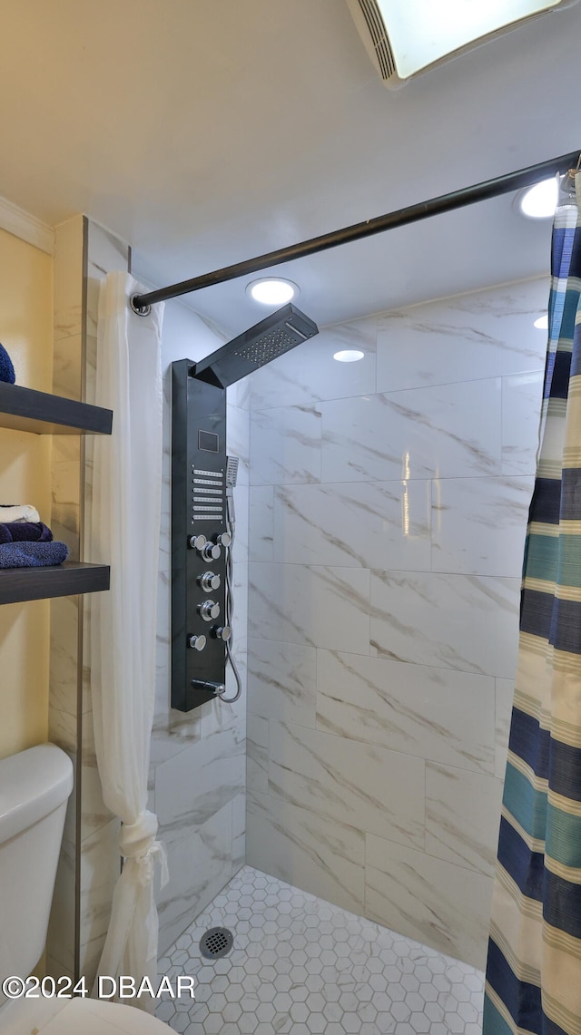 bathroom featuring toilet and a shower with shower curtain