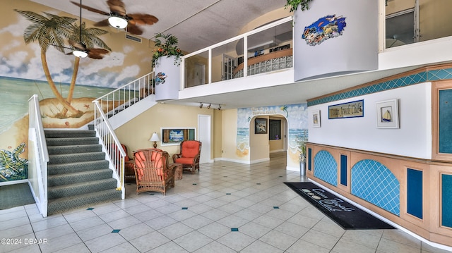 interior space featuring tile patterned flooring and ceiling fan