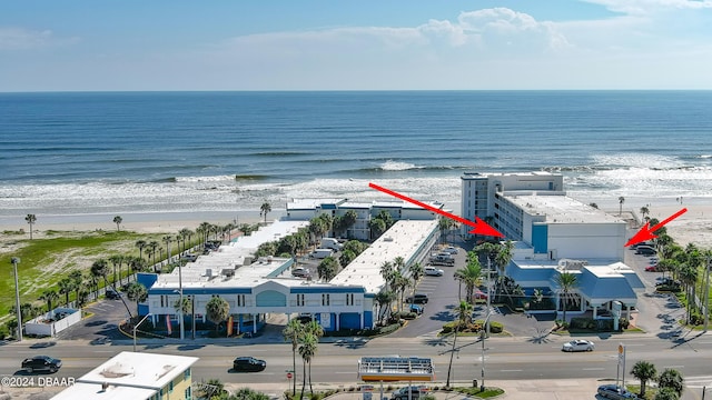 aerial view featuring a view of the beach and a water view