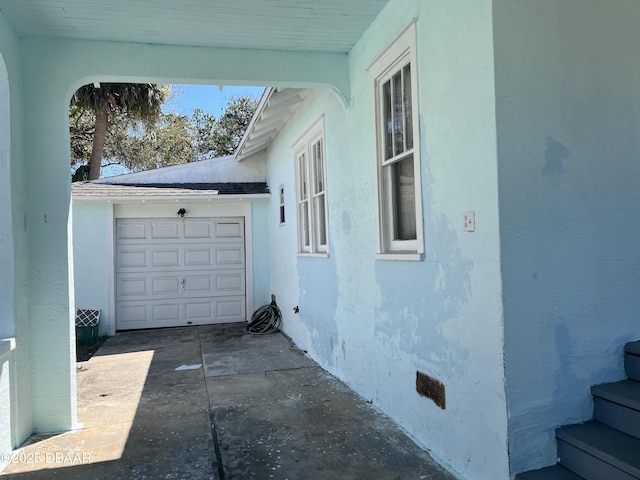 600 5th Ave, Daytona Beach, FL 32118 - view of side of home featuring stucco siding, driveway, and crawl space
