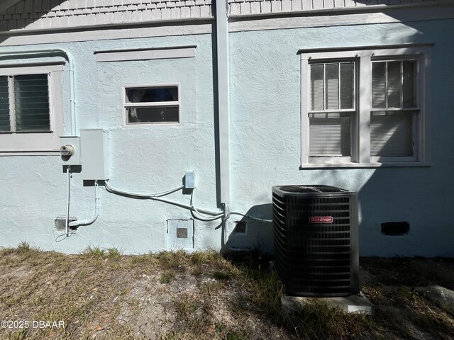 600 5th Ave, Daytona Beach, FL 32118 - view of home's exterior with stucco siding, central AC unit, and crawl space