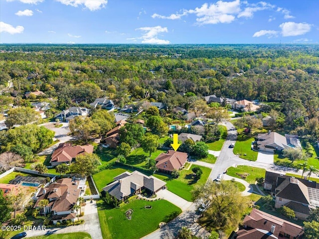 birds eye view of property with a forest view and a residential view