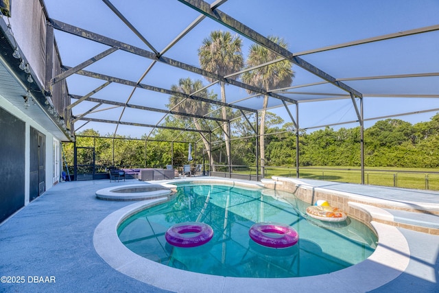 view of swimming pool featuring an in ground hot tub, a patio, and glass enclosure