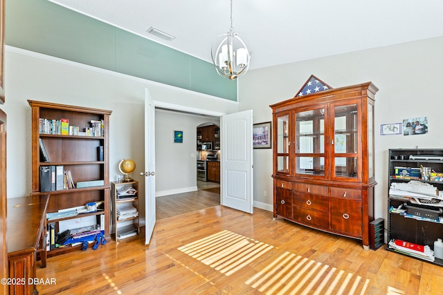 living area featuring hardwood / wood-style floors and a notable chandelier