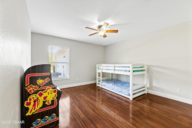 bedroom with dark hardwood / wood-style floors and ceiling fan